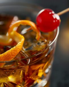 "A bartender skillfully preparing a Michter's Old Fashioned recipe, showcasing expertise and technique."