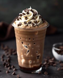 "Person enjoying a Starbucks double chocolate chip Frappuccino at an outdoor cafe."